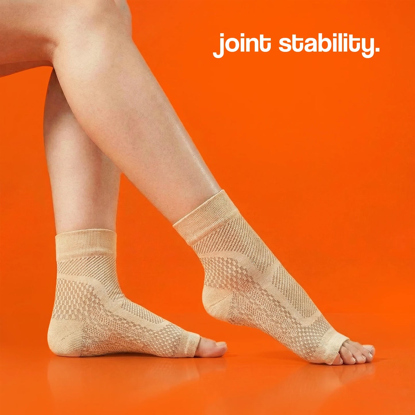 Beige compression socks displayed on a model's feet against an orange background, featuring a textured design for joint st...
