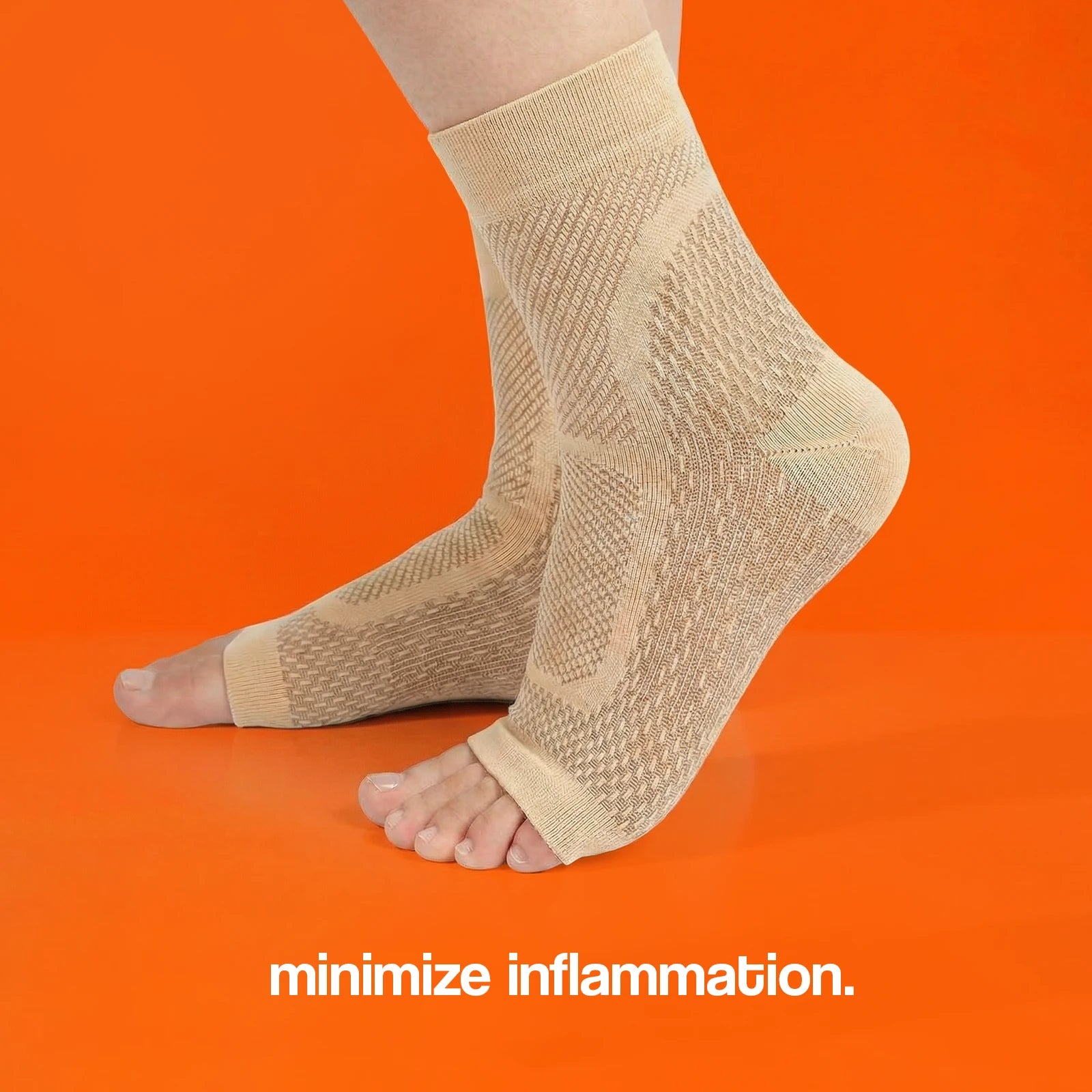 Beige compression socks with open toes, designed to minimize inflammation, displayed against an orange background.