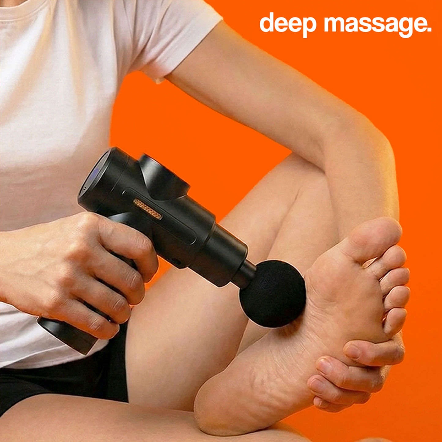 Black massage gun being used on the sole of a foot for a deep massage.